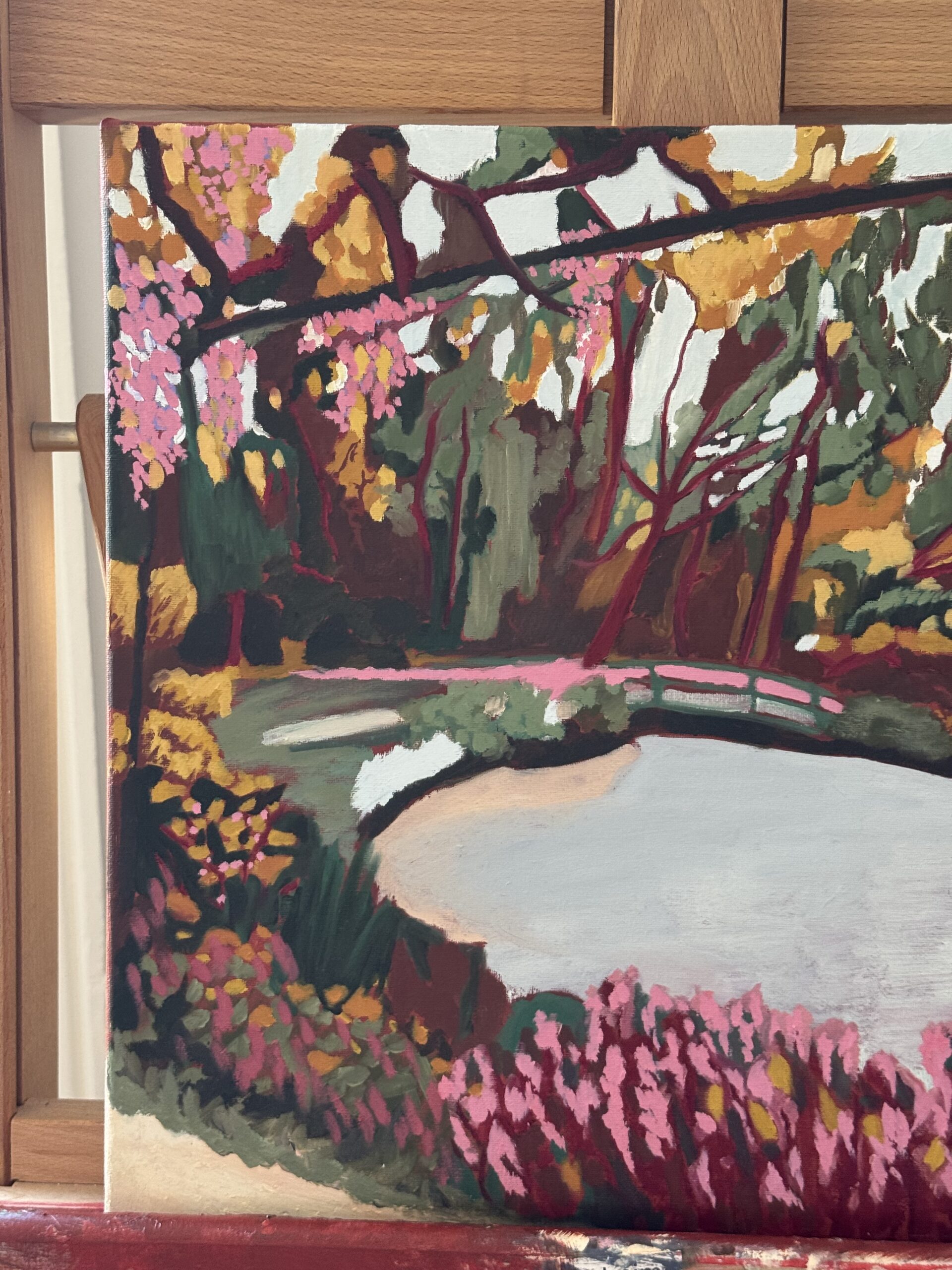 Monets' green bridge, oil on linen landscape by Diana Jarnea, hung on a wall